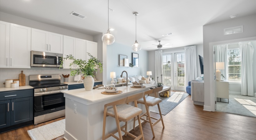 a kitchen with a large island and a living room