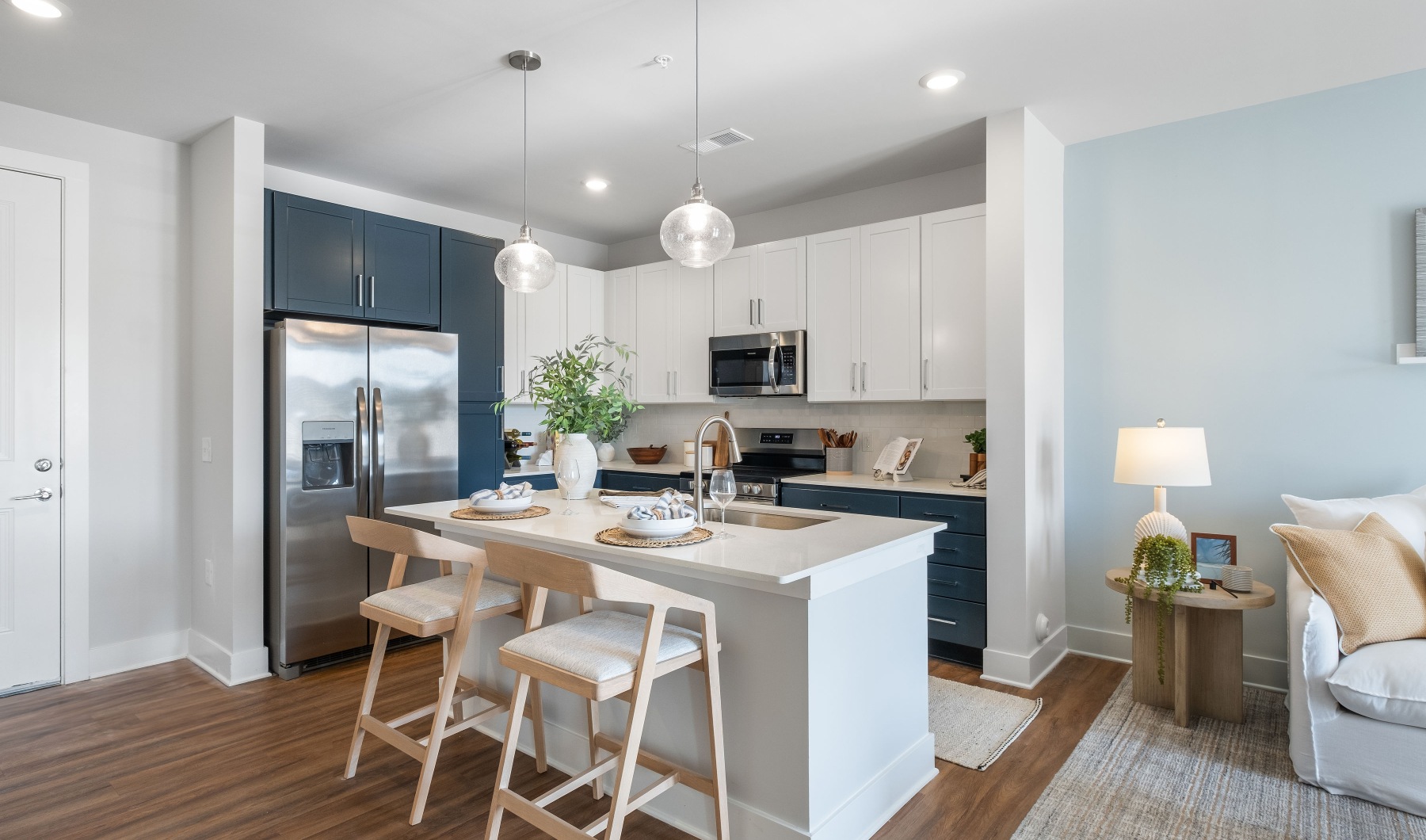 a kitchen with a large island and a living room