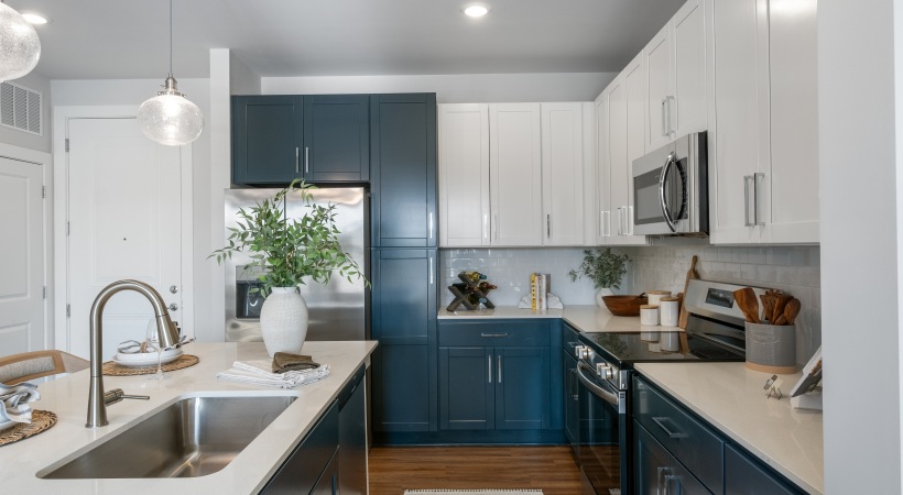 a kitchen with white and blue cabinets