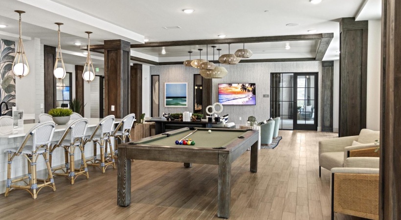 a clubroom with a pool table and chairs