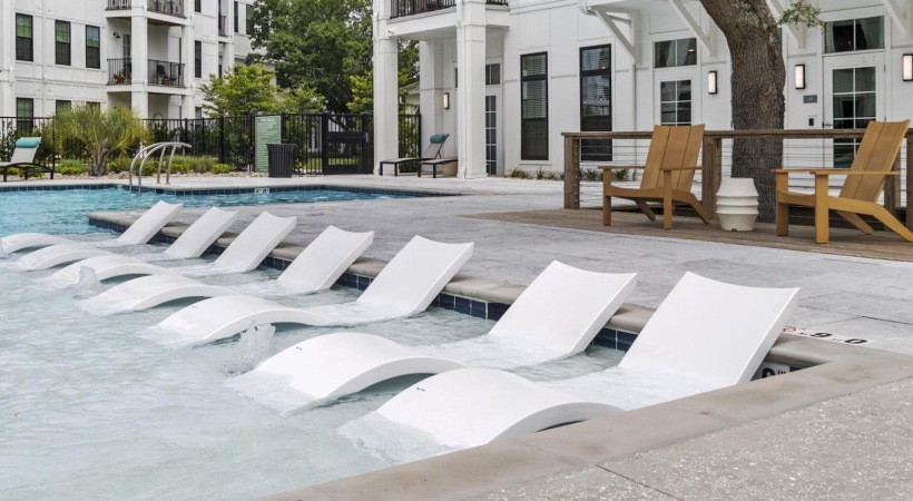 a swimming pool with lounge chairs