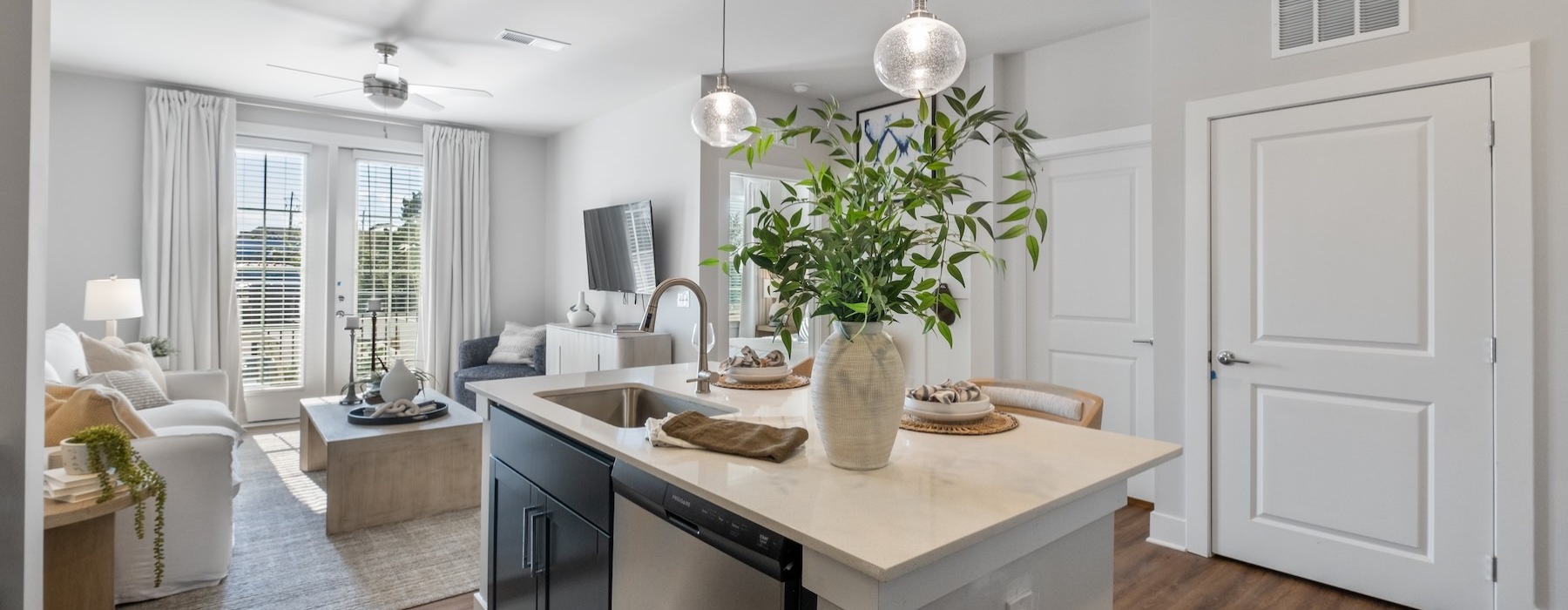 a kitchen with a large island and a living room