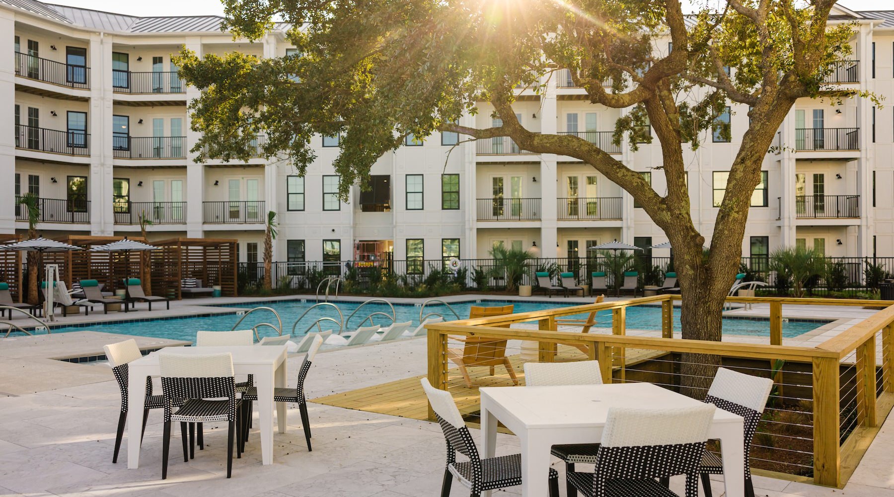 a swimming pool with tables and chairs