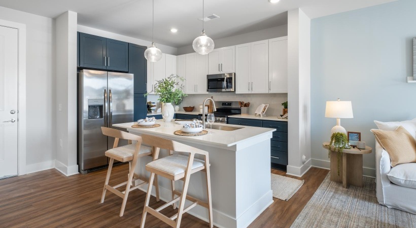 a kitchen with white and blue cabinets